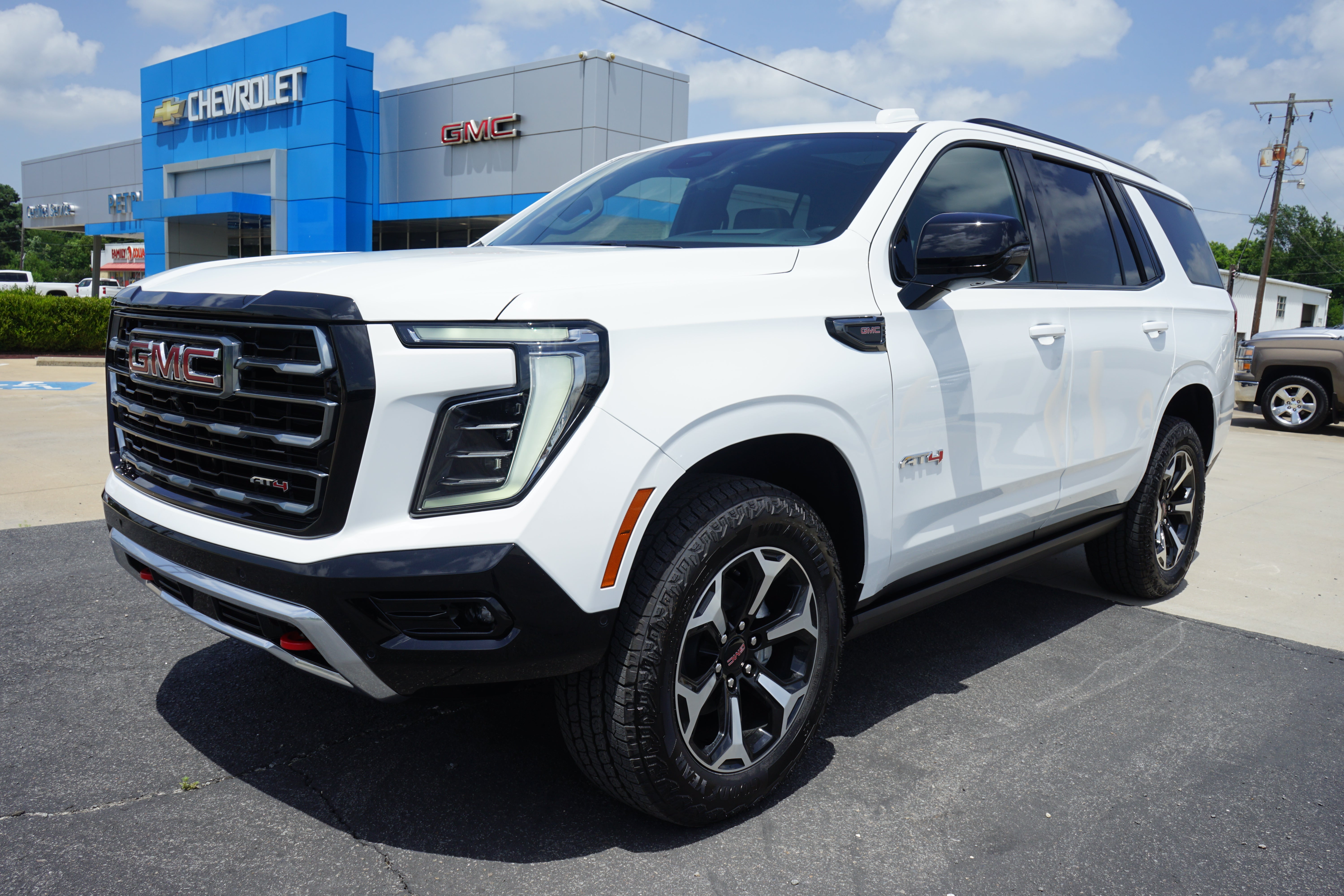 2026 GMC Yukon AT4 in Summit White — front three-quarter view
