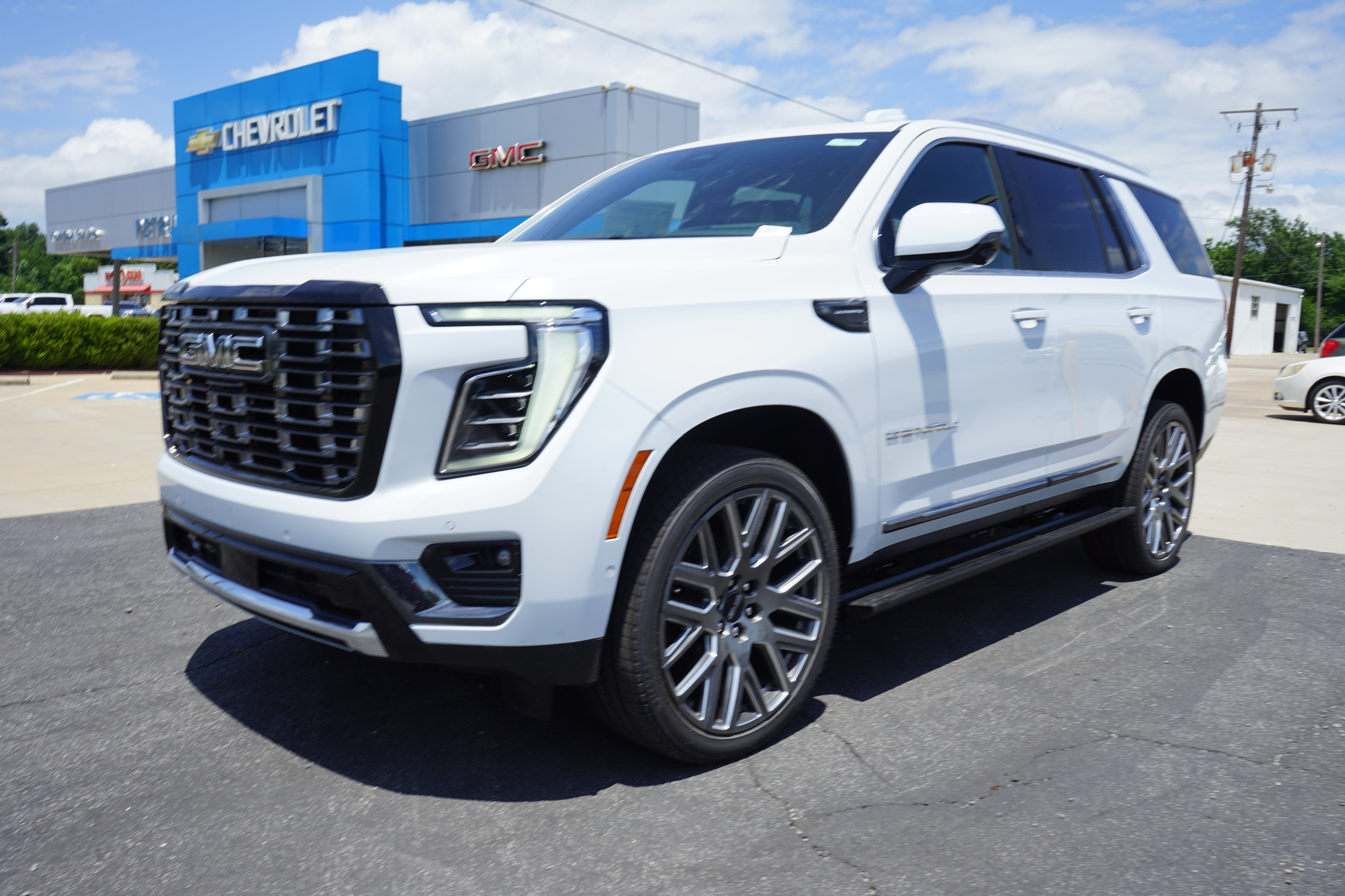 2026 GMC Yukon Denali Ultimate in Glacier White Tricoat — front three-quarter view