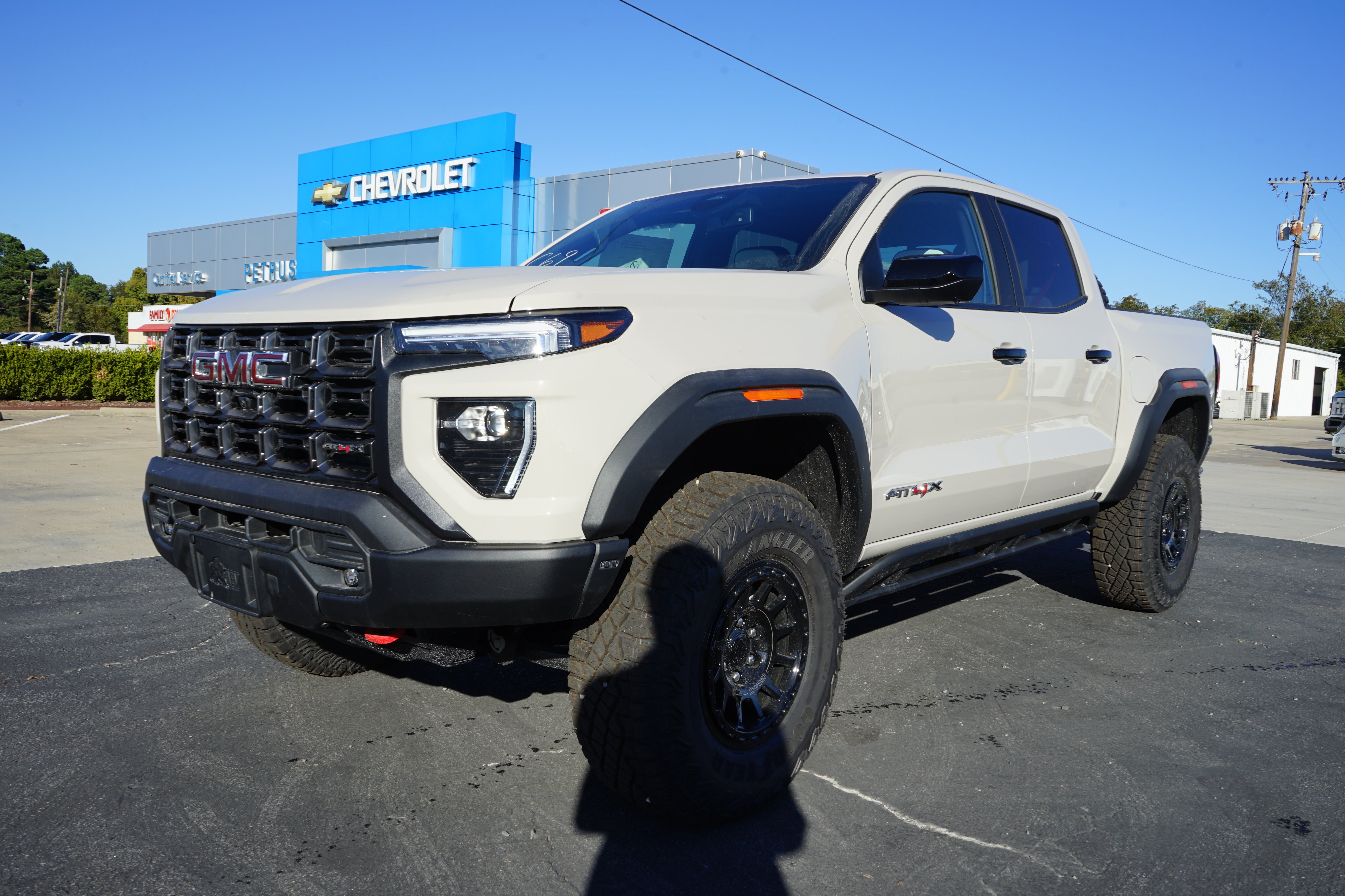 2026 GMC Canyon AT4X in Coastal Dune — front three-quarter view