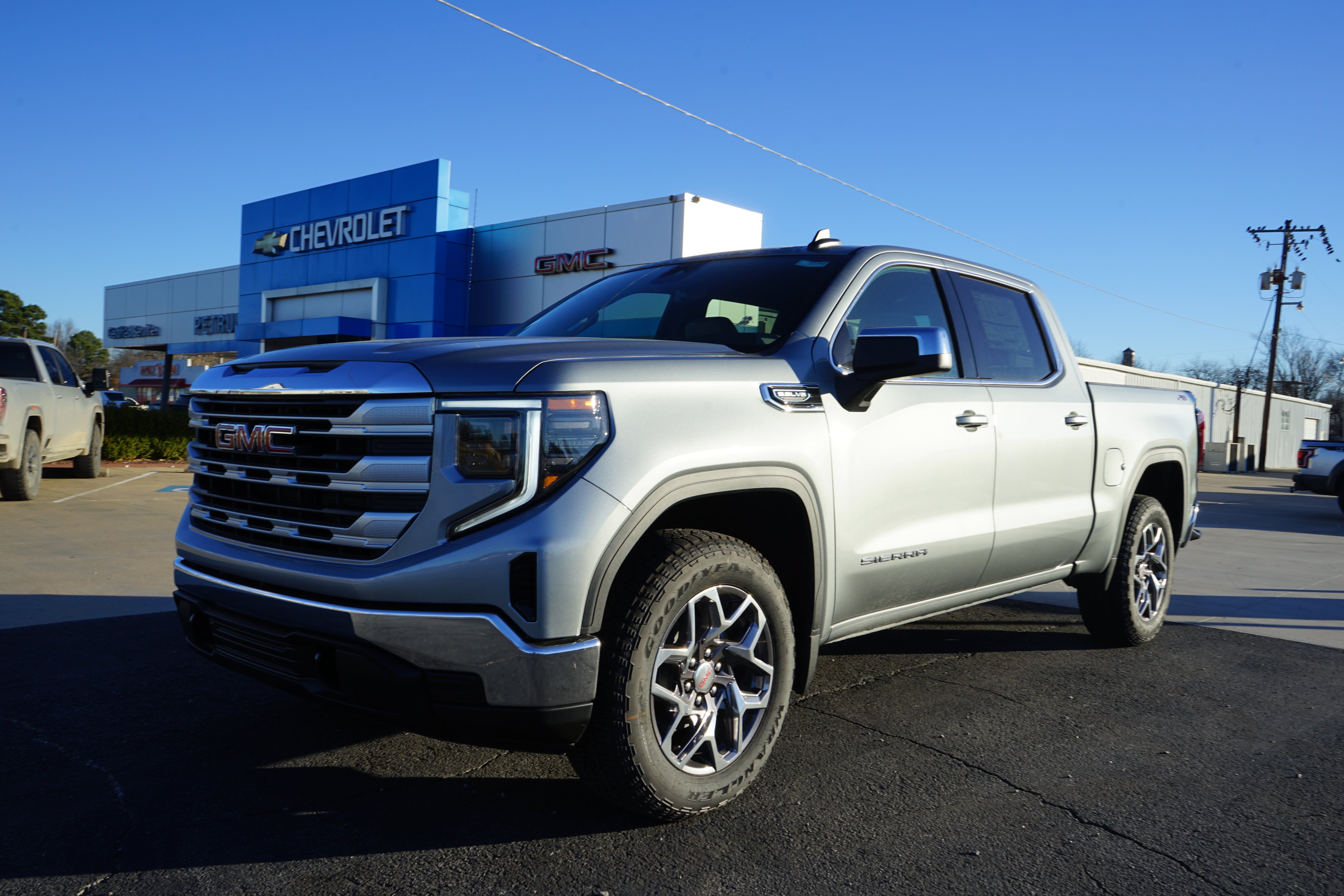 2026 GMC Sierra 1500 SLE in Sterling Metallic — front three-quarter view